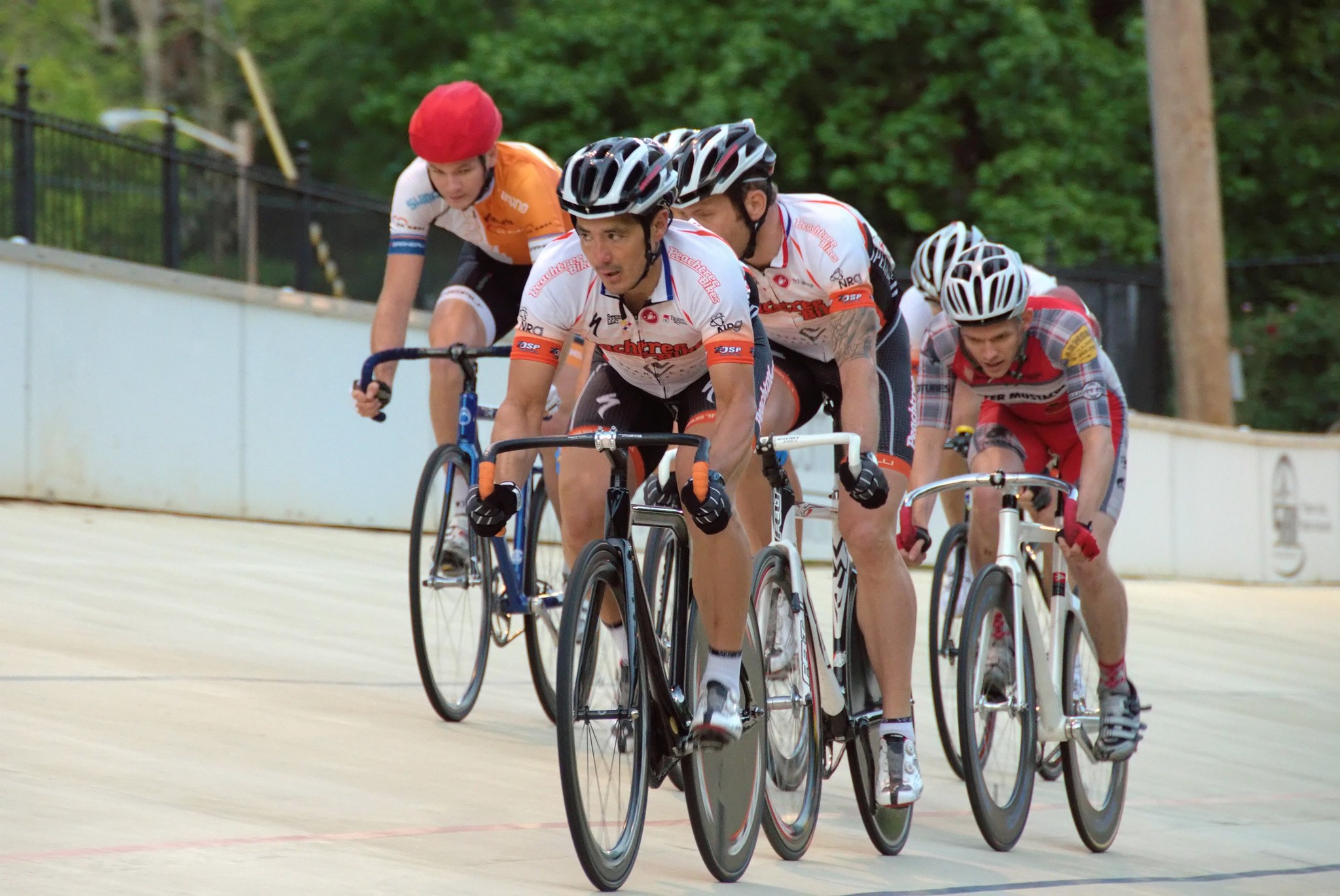 Bicycle riders racing in a velodrome track