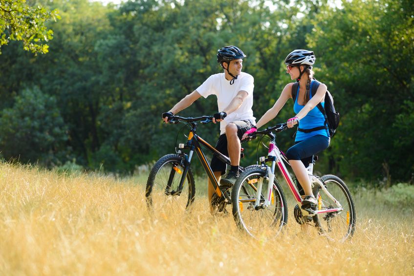 A couple riding bikes through Canton, GA