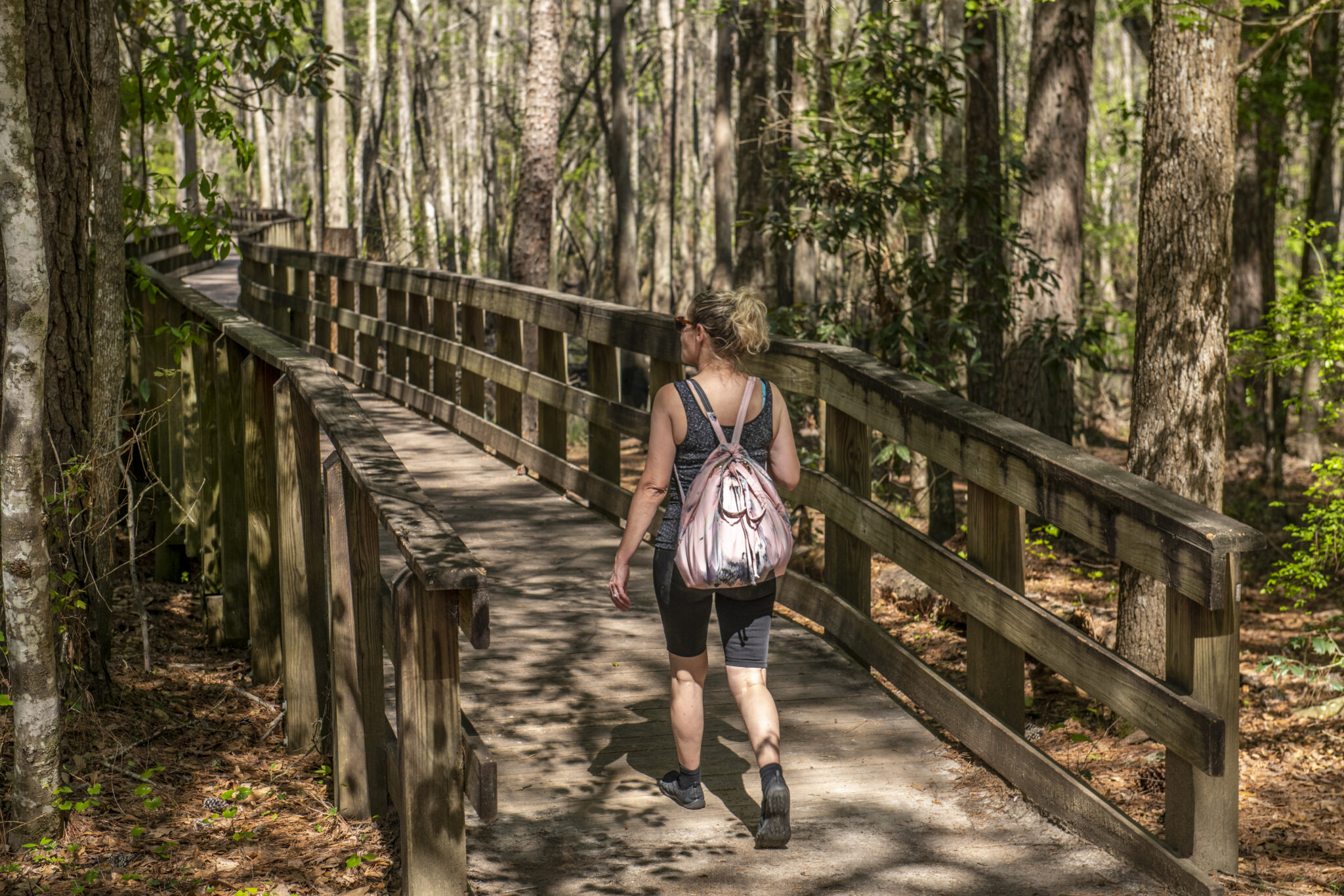 Woman walking on boardwalk